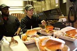 Kitchen staff preparing burgers at the Lunch Pail