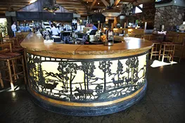 Rustic bar with etched wildlife metalwork panels